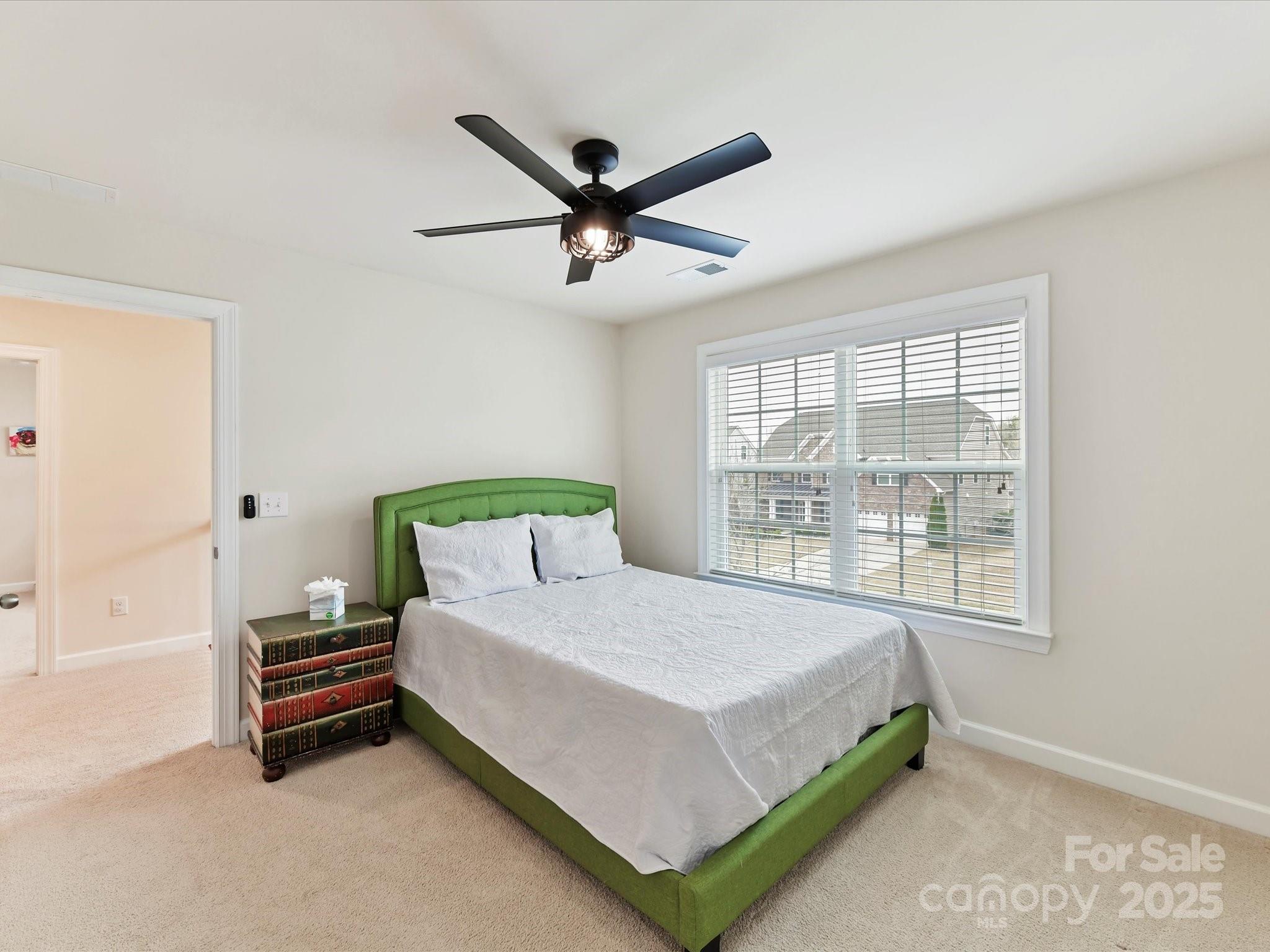 9895 Travertine Trail Davidson, NC 28036 - Photo 34 of 48 a bedroom with a bed and a window
