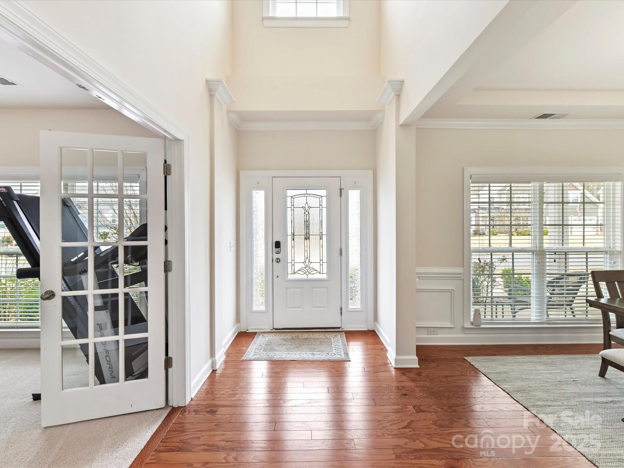 9895 Travertine Trail Davidson, NC 28036 - Photo 4 of 48 an empty room with wooden floor and windows