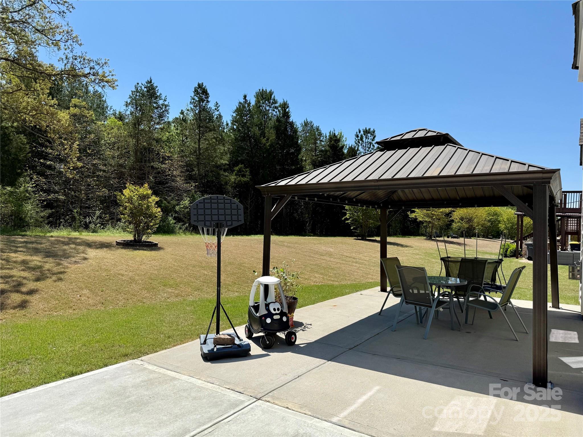 9895 Travertine Trail Davidson, NC 28036 - Photo 42 of 48 a view of a swimming pool with lawn chairs under an umbrella