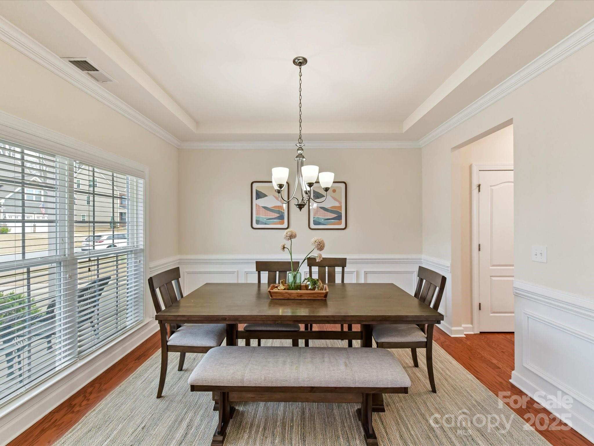 9895 Travertine Trail Davidson, NC 28036 - Photo 5 of 48 a dining room with furniture a rug and wooden floor