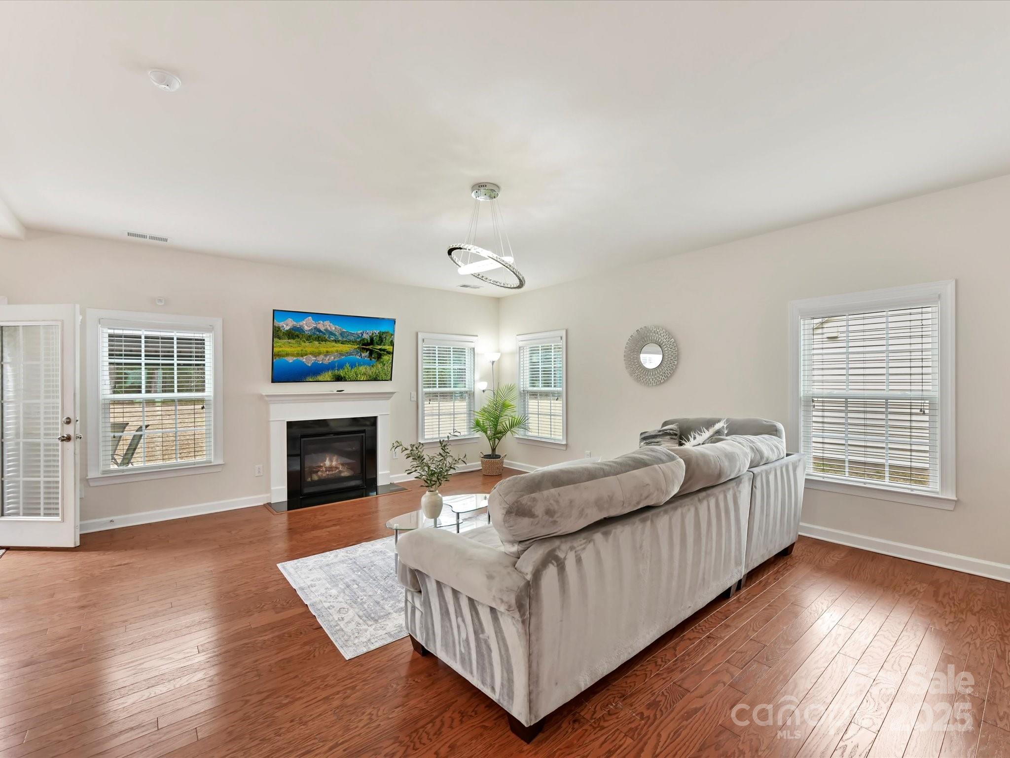 9895 Travertine Trail Davidson, NC 28036 - Photo 9 of 48 a living room with furniture and a fireplace