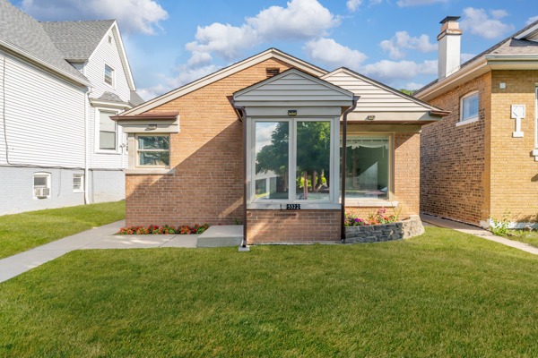 a view of a house with a yard patio and a garden