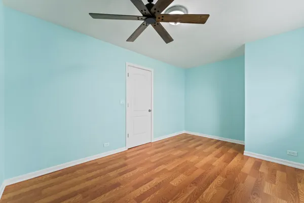 an empty room with closet and fan