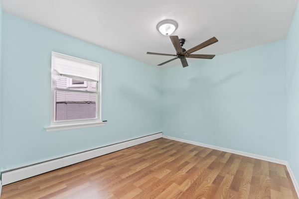 5322 West Addison Street Chicago, IL 60641 - Photo 15 of 21 an empty room with a window and a fan
