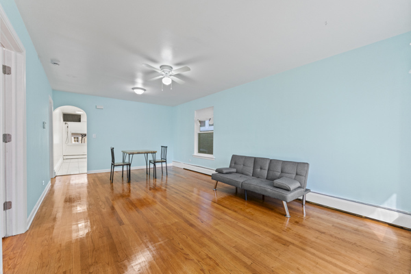 5322 West Addison Street Chicago, IL 60641 - Photo 3 of 21 a living room with furniture and a table with wooden floor