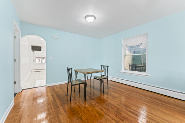 5322 West Addison Street Chicago, IL 60641 - Photo 6 of 21 a view of a room with furniture window and wooden floor