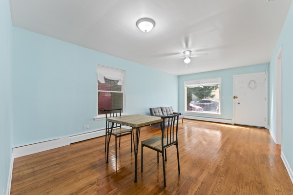 5322 West Addison Street Chicago, IL 60641 - Photo 7 of 21 a view of a dining room with furniture and wooden floor