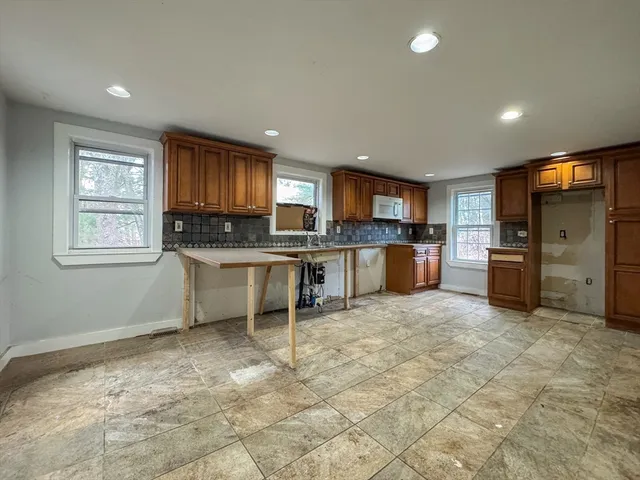 a kitchen with stainless steel appliances granite countertop a refrigerator sink and cabinets
