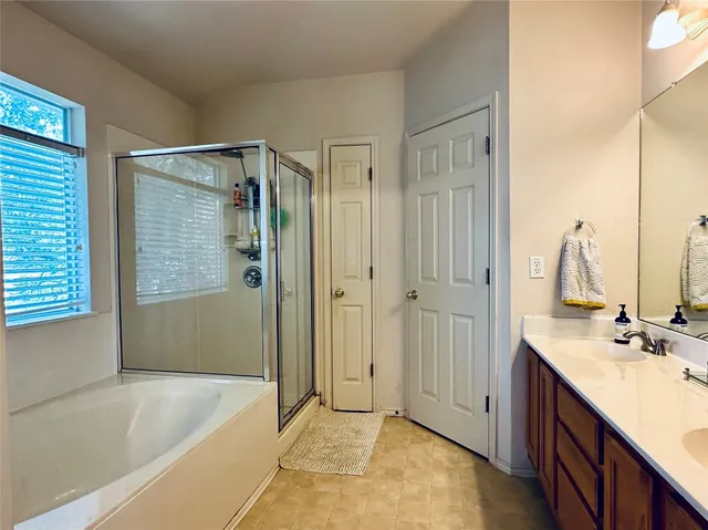 a bathroom with a tub sink and mirror