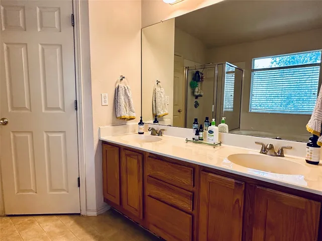 a bathroom with a double vanity sink and a mirror