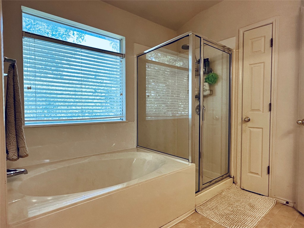 8300 Alvin High Lane Austin, TX 78729 - Photo 14 of 21 a bathroom with a bathtub and a shower
