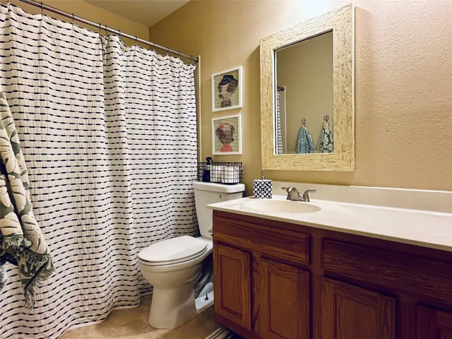a bathroom with a toilet a sink and mirror