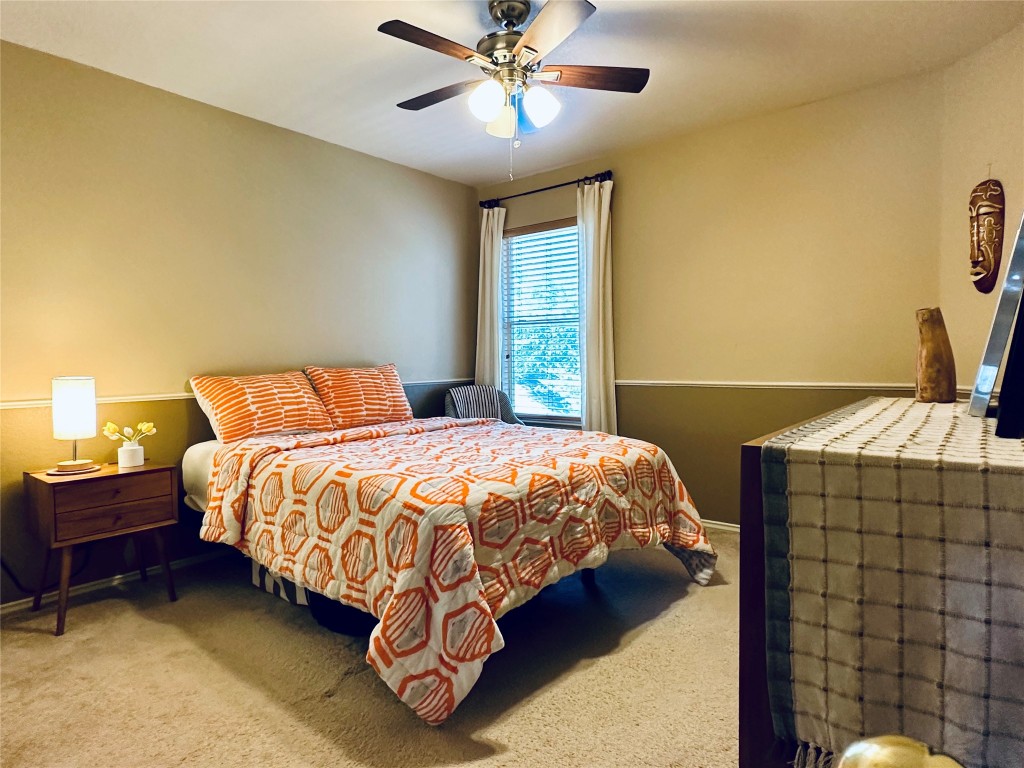 8300 Alvin High Lane Austin, TX 78729 - Photo 18 of 21 a bedroom with a bed and a chandelier