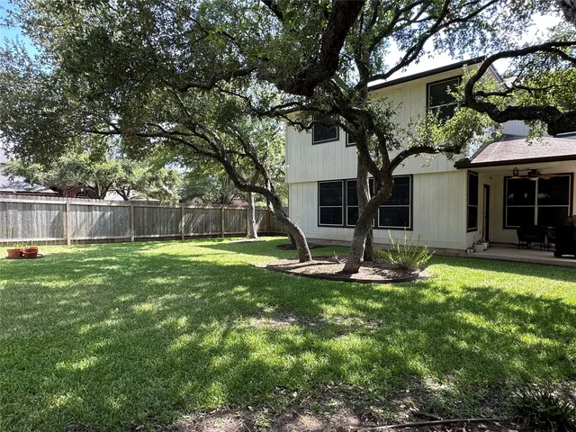 a backyard of a house with table and chairs