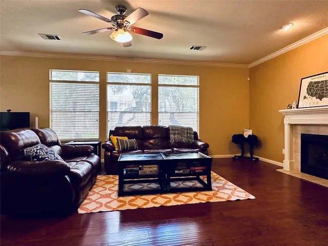a living room with furniture fireplace and a large window