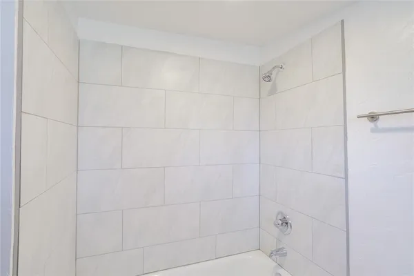 a bathroom with a sink a large mirror and a window