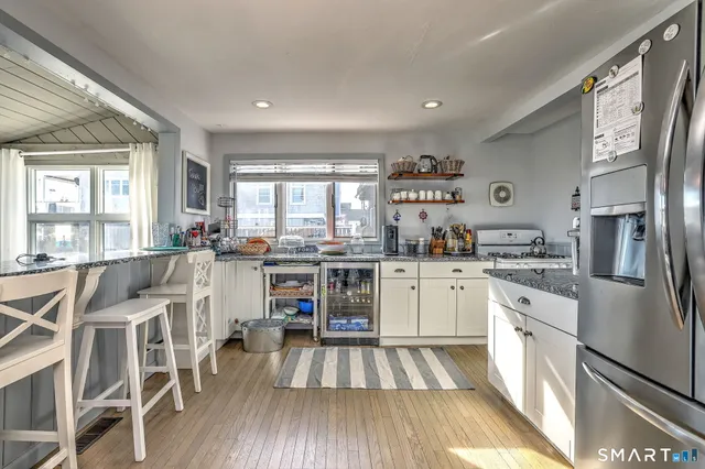 a kitchen with white cabinets and stainless steel appliances