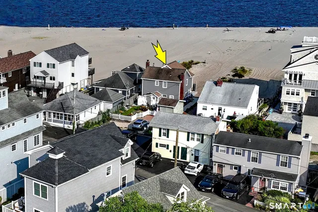 an aerial view of multiple houses with a street