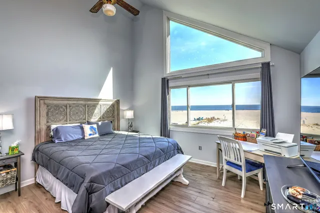 a bedroom with a large bed and a desk