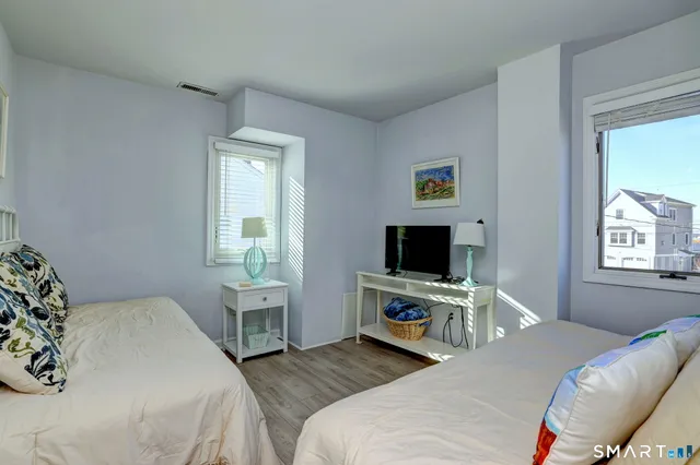 a bedroom with a bed and a tv