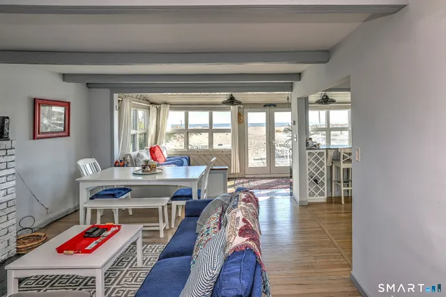a view of a workspace with furniture window and wooden floor