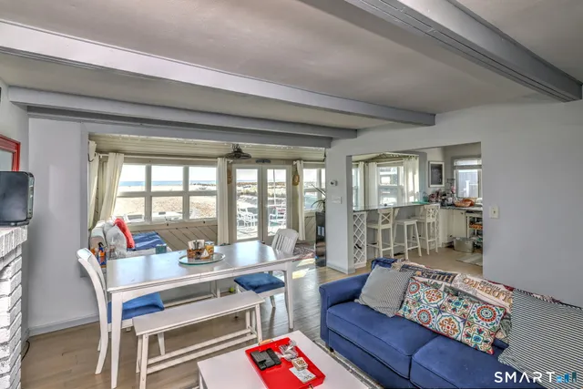 a living room with furniture and a floor to ceiling window