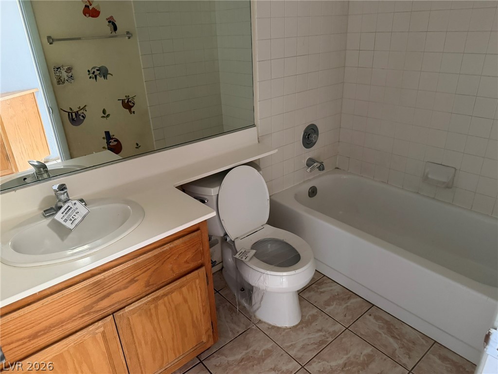 277 Gentle Bay Avenue Henderson, NV 89074 - Photo 32 of 43 This bathroom features a functional vanity, toilet, and a clean tub-shower combination.