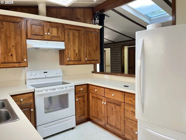 a kitchen with a sink and a large window