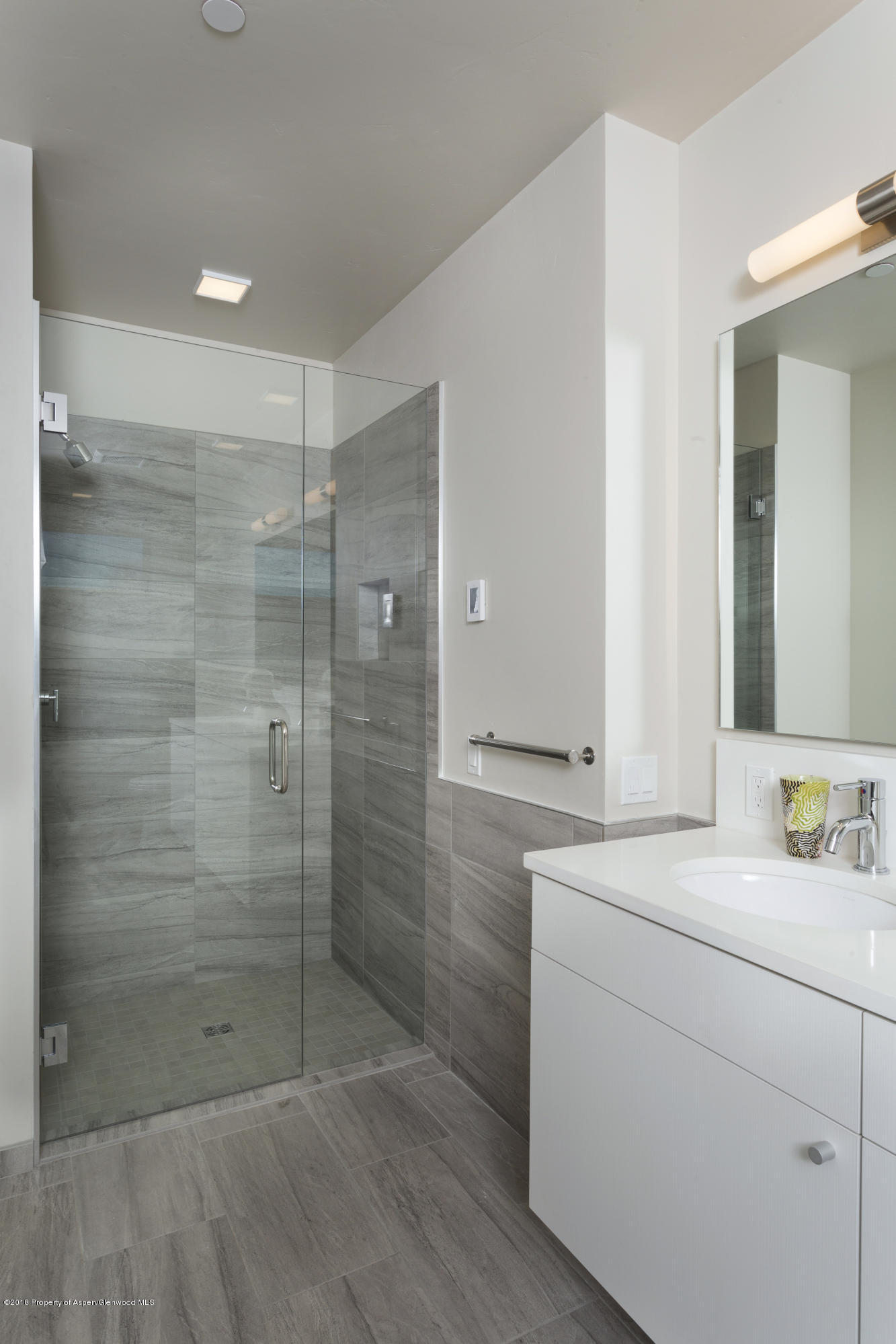 102 Evans Road, Unit 107 Basalt, CO 81621 - Photo 49 of 62 a bathroom with a shower sink and mirror