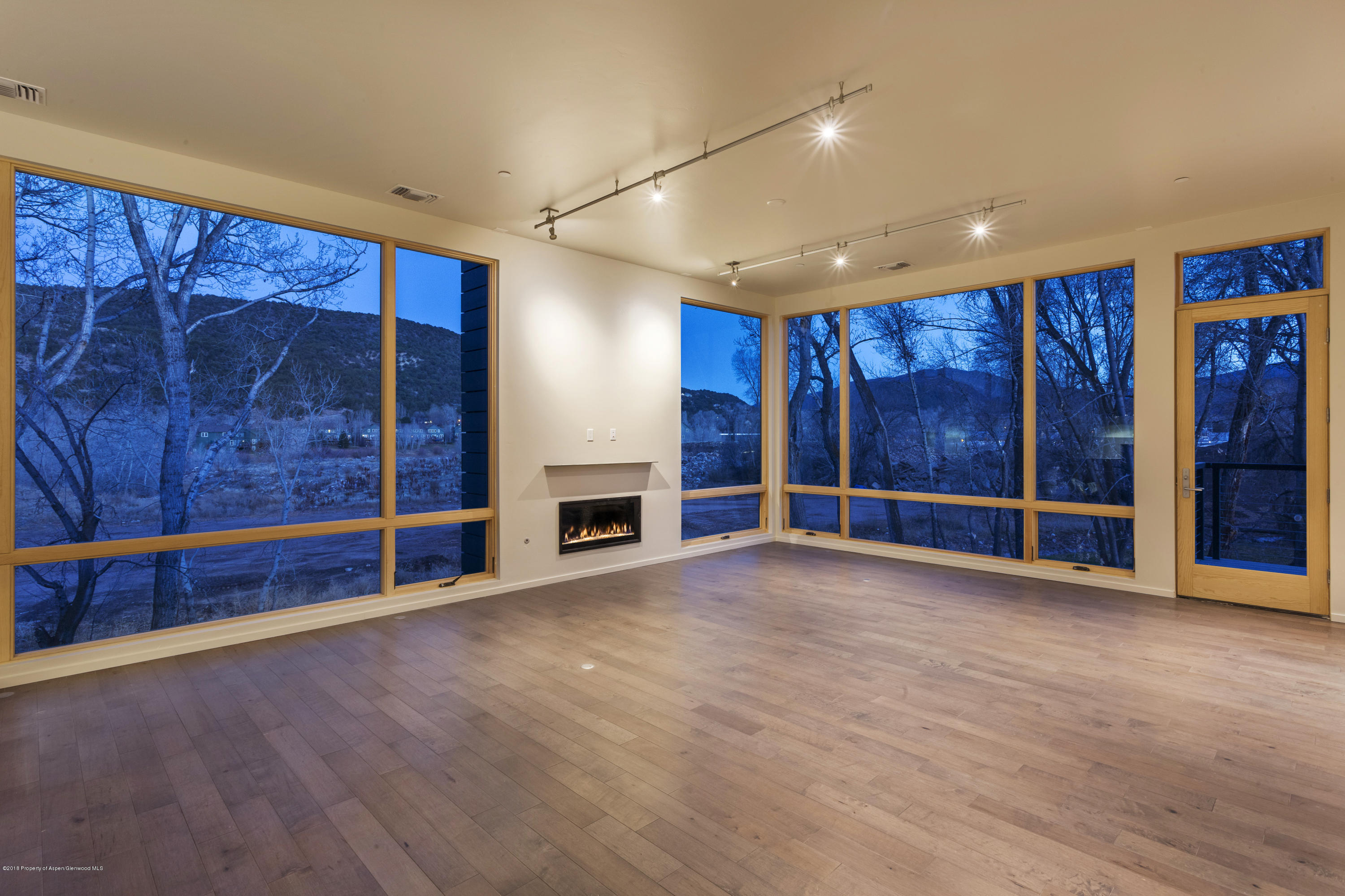 102 Evans Road, Unit 107 Basalt, CO 81621 - Photo 52 of 62 a view of an empty room with wooden floor and fan