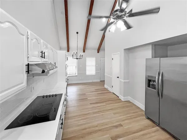 a view of a kitchen with a sink and refrigerator