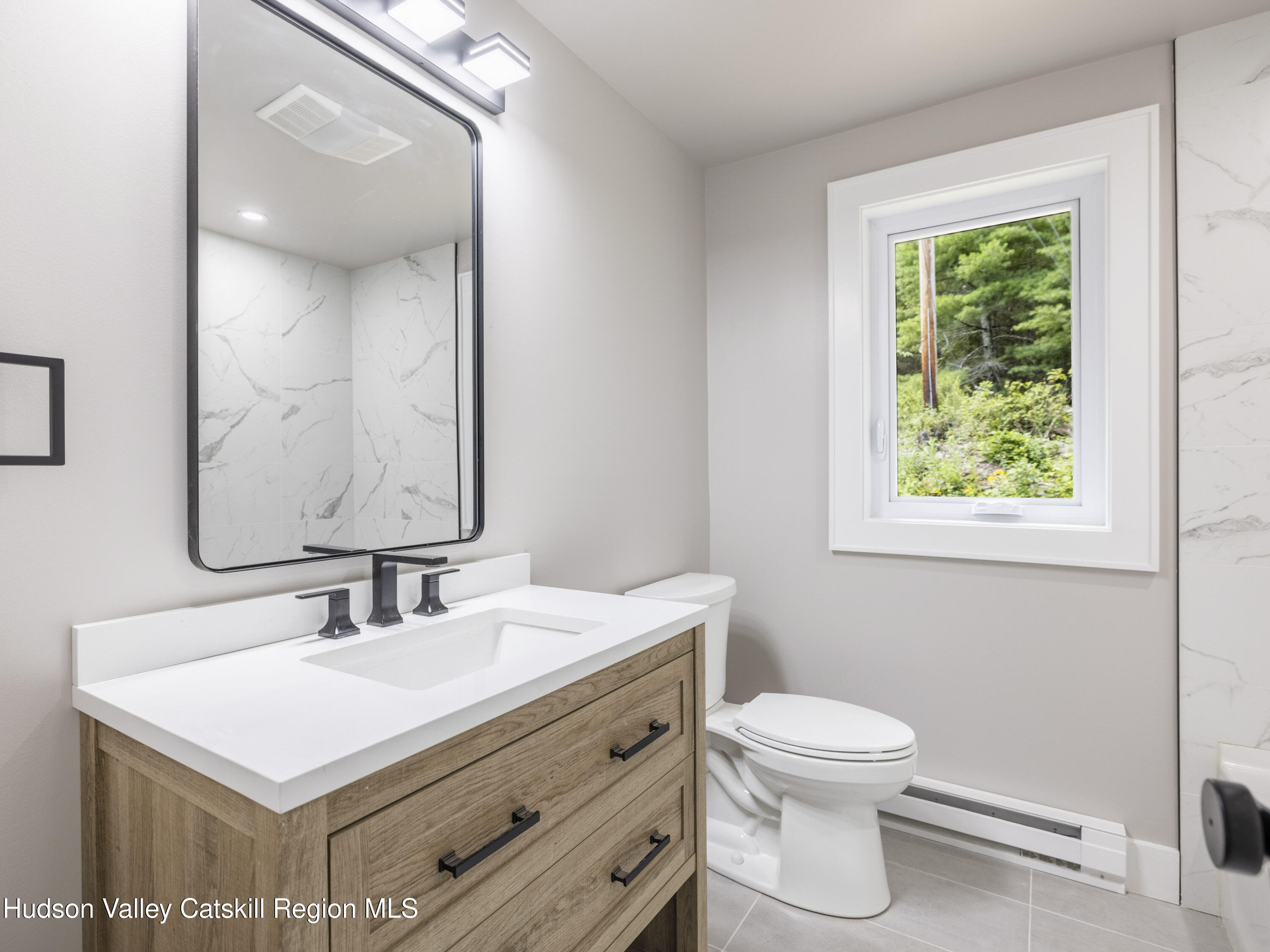14 Goat Hill Road Saugerties, NY 12477 - Photo 15 of 26 a bathroom with a sink a toilet and a mirror