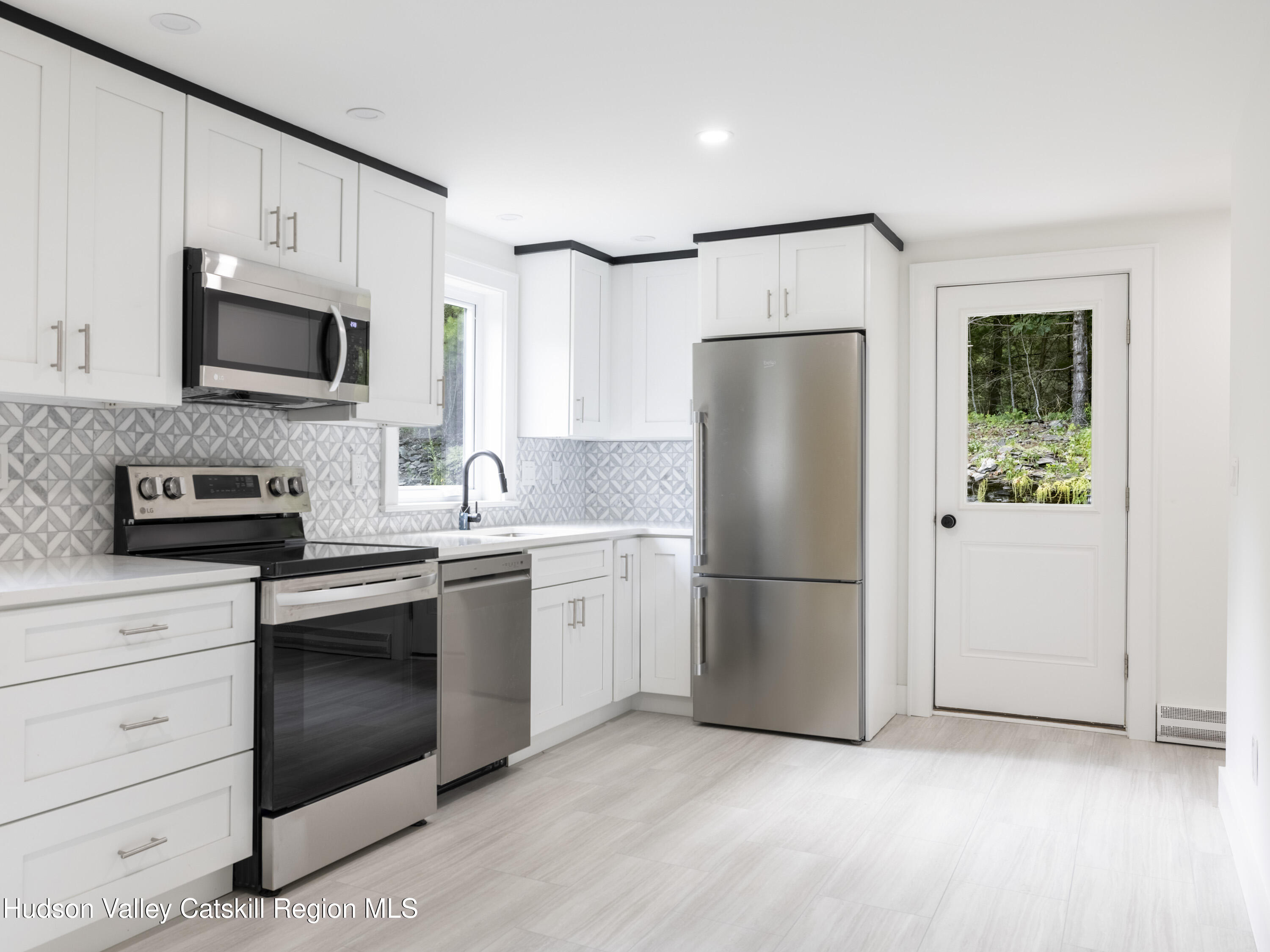 14 Goat Hill Road Saugerties, NY 12477 - Photo 5 of 26 a white refrigerator freezer sitting in a kitchen