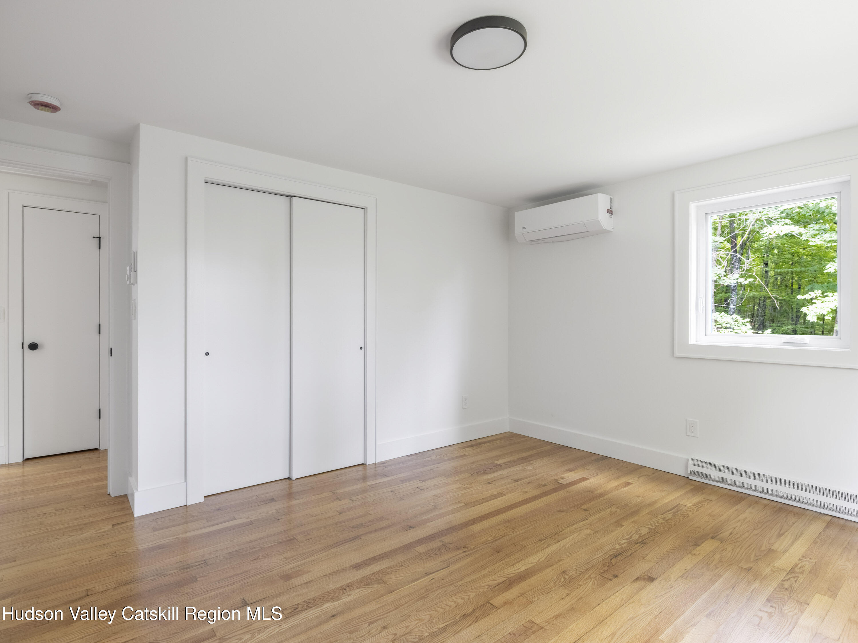 14 Goat Hill Road Saugerties, NY 12477 - Photo 9 of 26 a view of empty room with wooden floor and fan