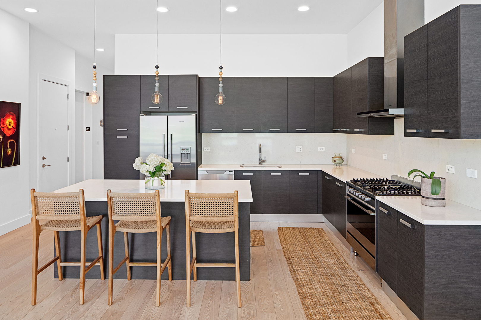128 South Aberdeen Street, Unit 2N Chicago, IL 60607 - Photo 10 of 31 a kitchen with stainless steel appliances kitchen island granite countertop a sink and cabinets
