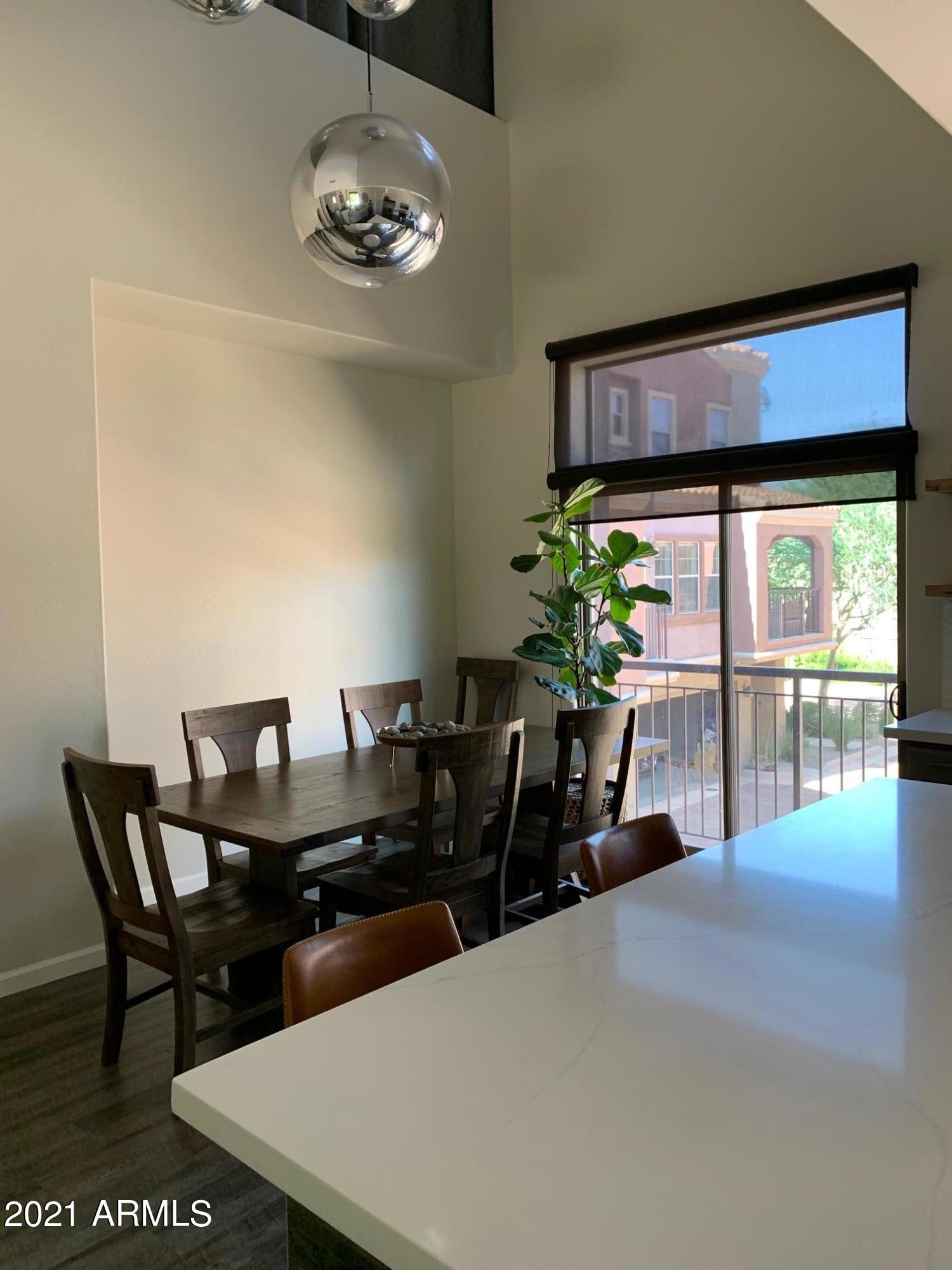 3935 East Rough Rider Road, Unit 1005 Phoenix, AZ 85050 - Photo 16 of 60 Full Dining Table and Slider View