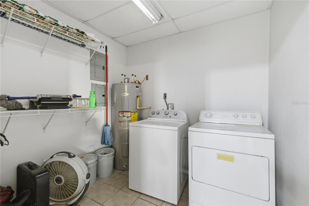 9900 Southeast Sunset Harbor Road Summerfield, FL 34491 - Photo 12 of 44 a utility room with dryer and washer