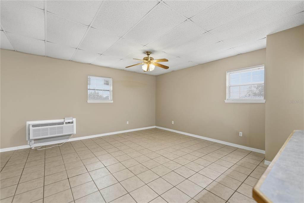 9900 Southeast Sunset Harbor Road Summerfield, FL 34491 - Photo 13 of 44 a view of an empty room with a window
