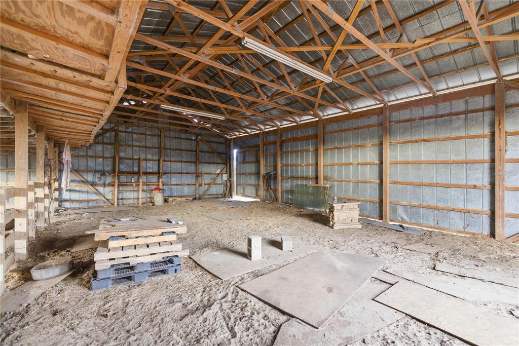9900 Southeast Sunset Harbor Road Summerfield, FL 34491 - Photo 26 of 44 a view of a garage with wooden roof