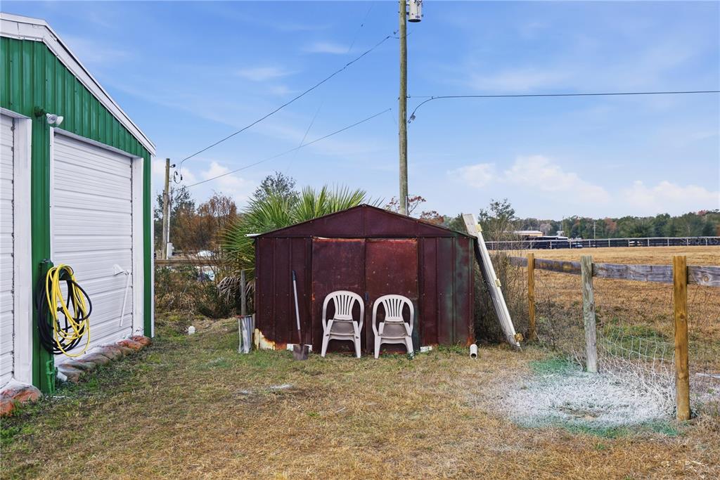 9900 Southeast Sunset Harbor Road Summerfield, FL 34491 - Photo 32 of 44 a view of a wooden fence next to a yard