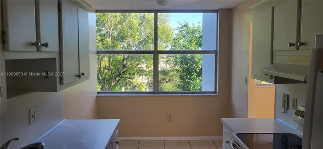 a kitchen with cabinets and washer dryer