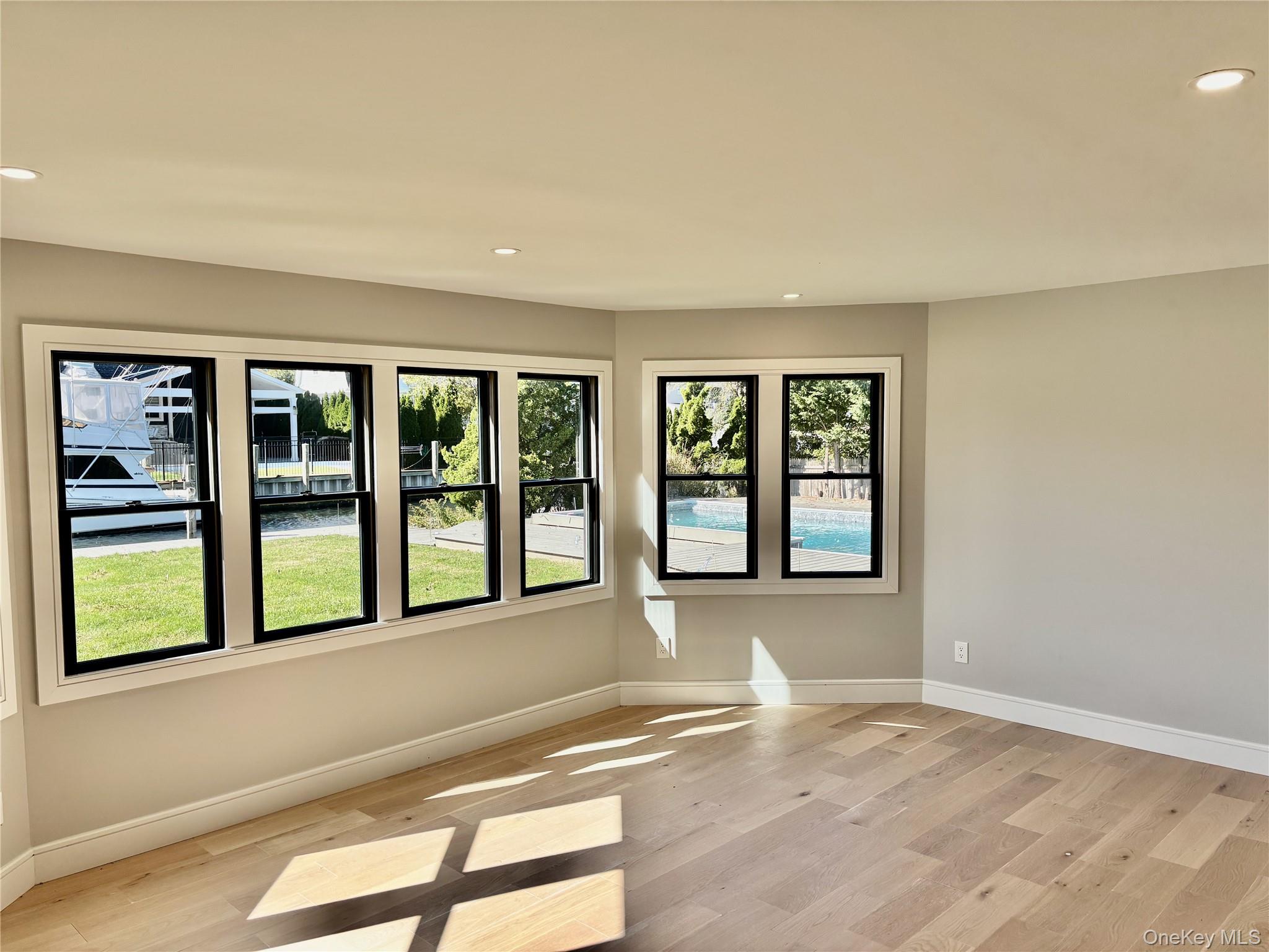 188 Sequams Lane Centre West Islip, NY 11795 - Photo 11 of 27 a view of an empty room with a window and wooden floor
