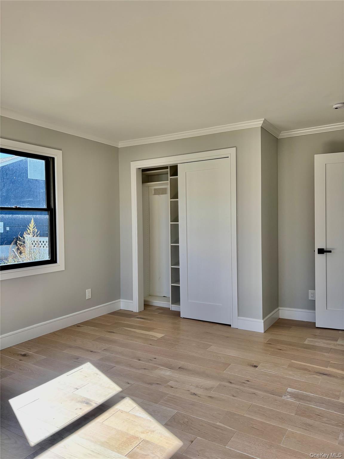 188 Sequams Lane Centre West Islip, NY 11795 - Photo 14 of 27 a view of an empty room with wooden floor and window