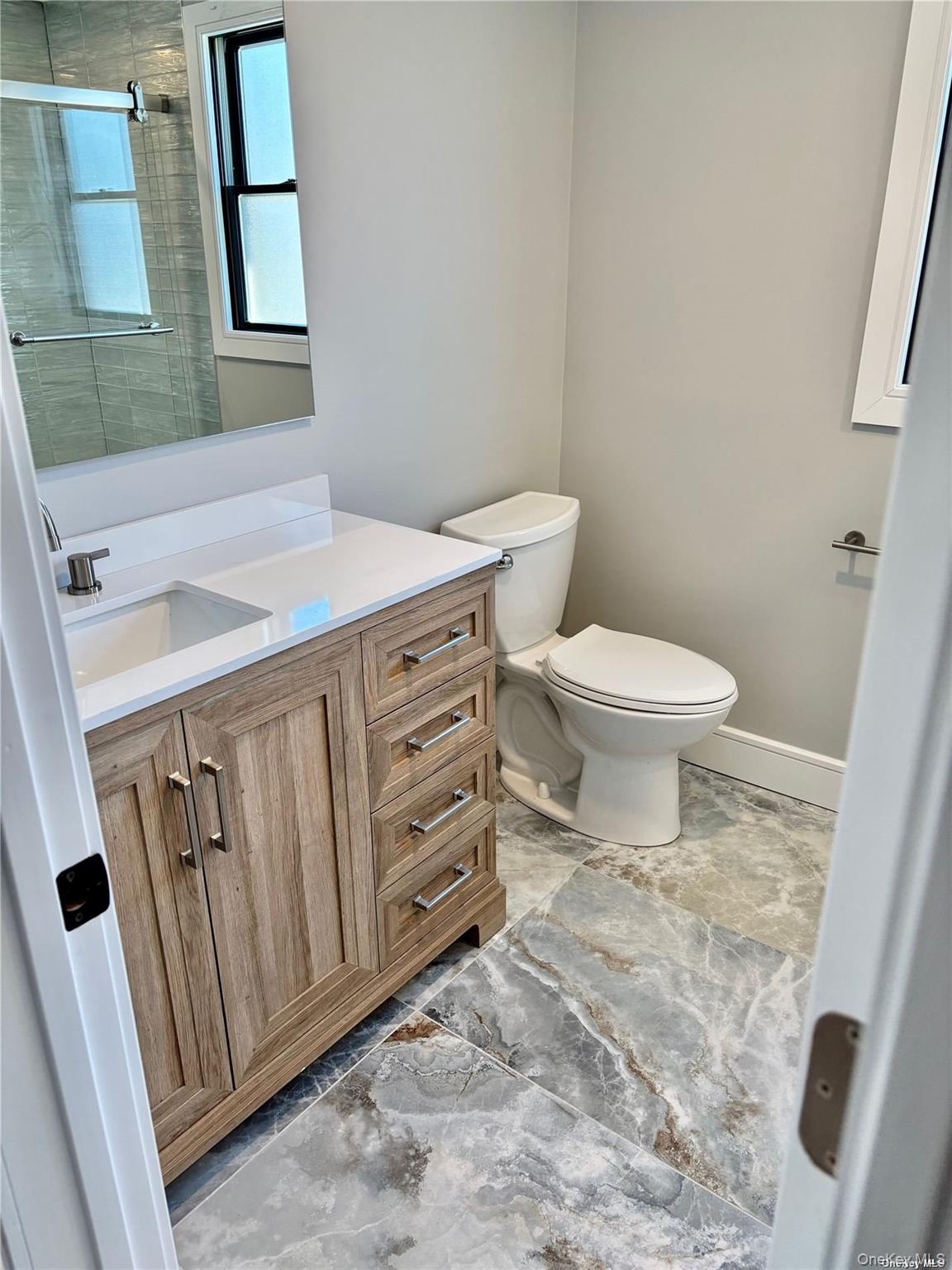 188 Sequams Lane Centre West Islip, NY 11795 - Photo 19 of 27 a bathroom with a toilet sink and mirror