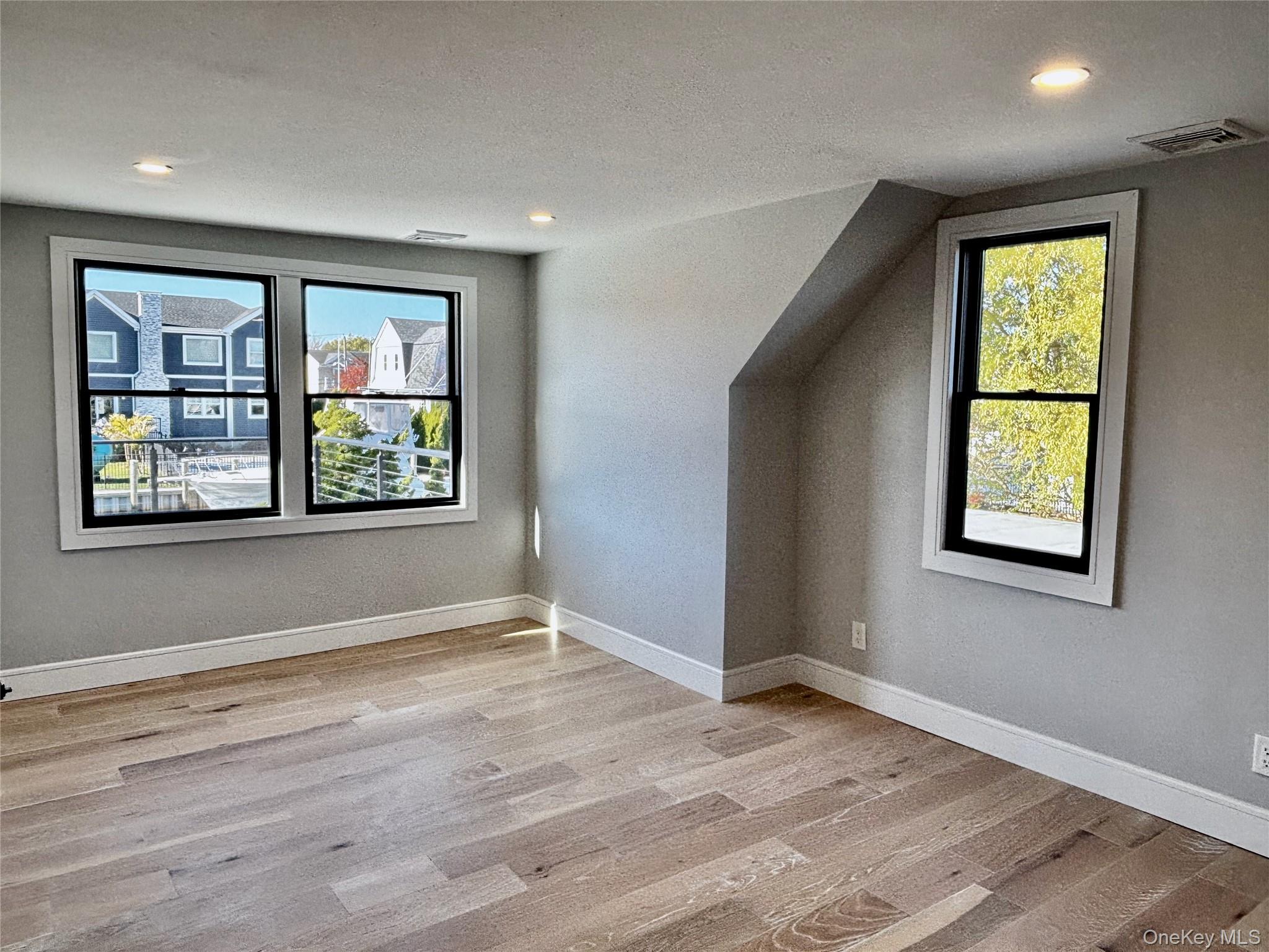 188 Sequams Lane Centre West Islip, NY 11795 - Photo 21 of 27 an empty room with windows and closet