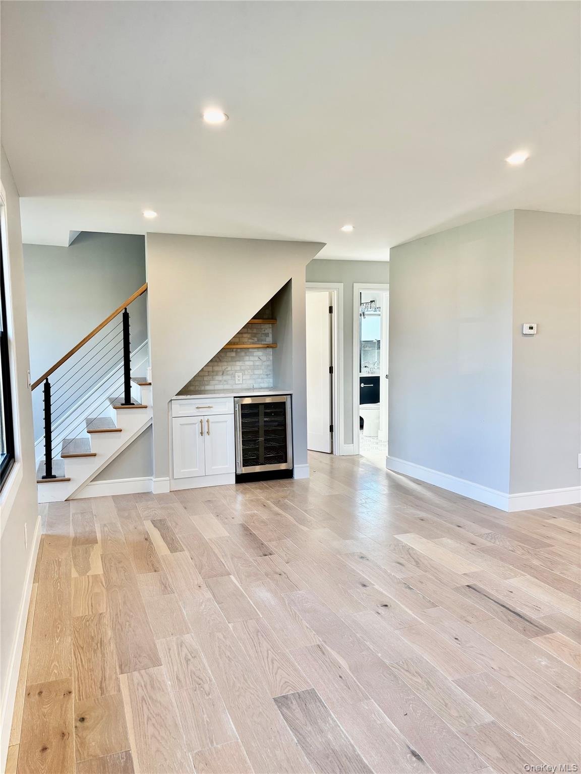 188 Sequams Lane Centre West Islip, NY 11795 - Photo 4 of 27 a view of a livingroom with wooden floor and staircase