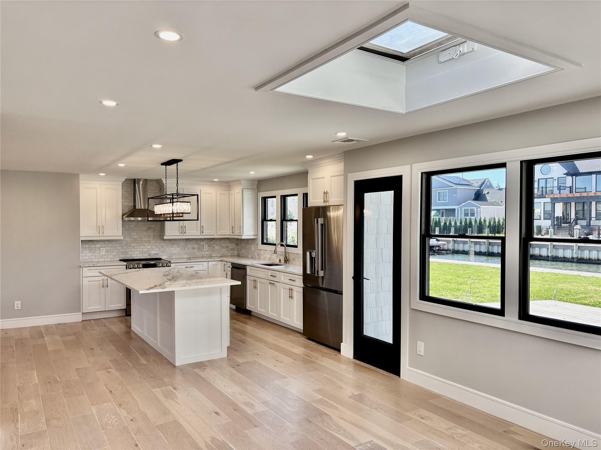 188 Sequams Lane Centre West Islip, NY 11795 - Photo 6 of 27 a kitchen with stainless steel appliances a stove a refrigerator and a sink