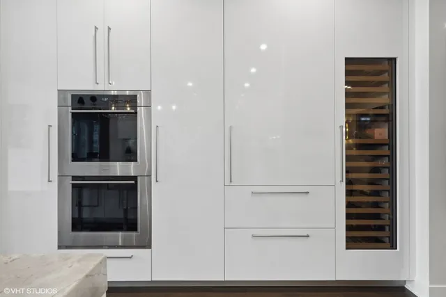 a view of a hallway with wooden floor and cabinet