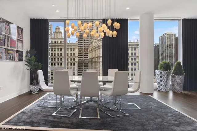 a view of a dining room with furniture and chandelier