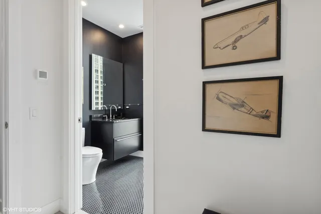 a bathroom with a toilet and a view of a bathroom